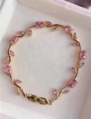Tulip Bracelet features pink crystal stones set in a gold-plated
