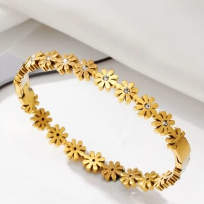 Daisy bangle is crafted from tarnish-resistant stainless steel and features small synthetic zirconia crystals in the center of each flower